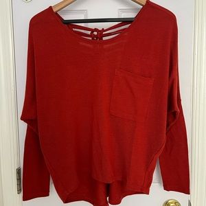 Open back detailing knit top with high low hemline in rust